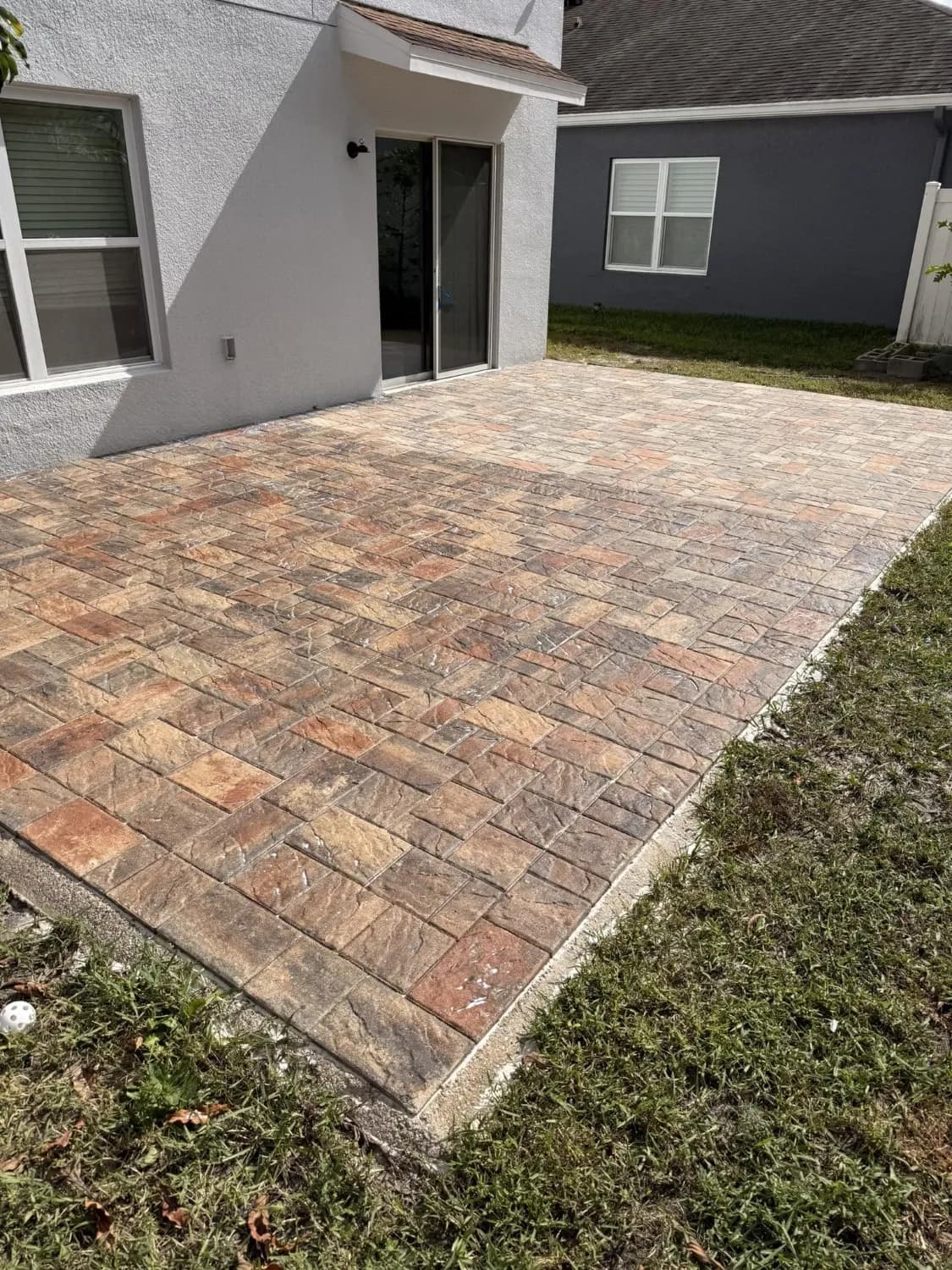A brick paver patio with a rich wet-look finish after cleaning and sealing